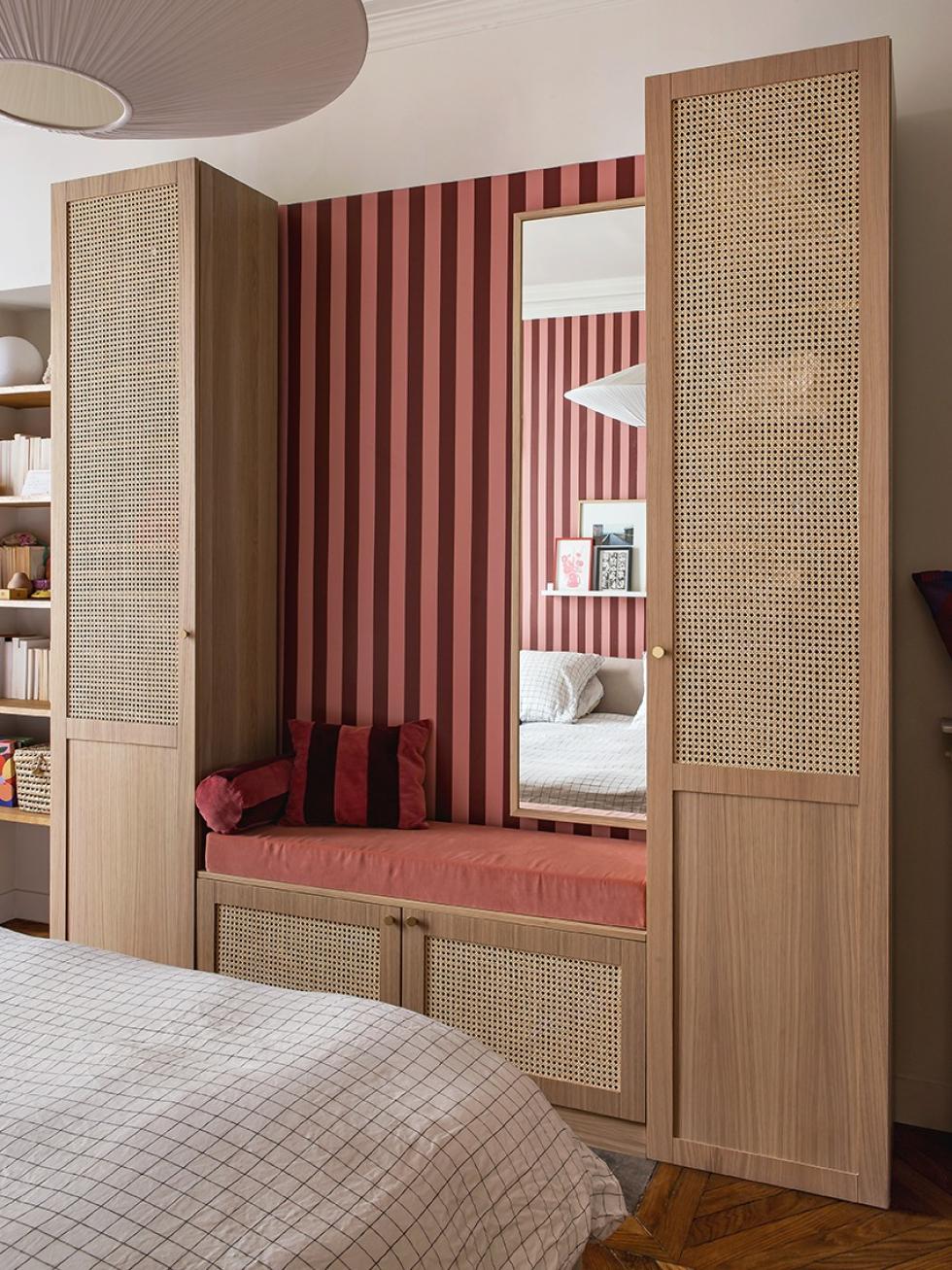 Lisa Gachet's bedroom, with burgundy and pink wallpaper, and a cane and oak wardrobe.