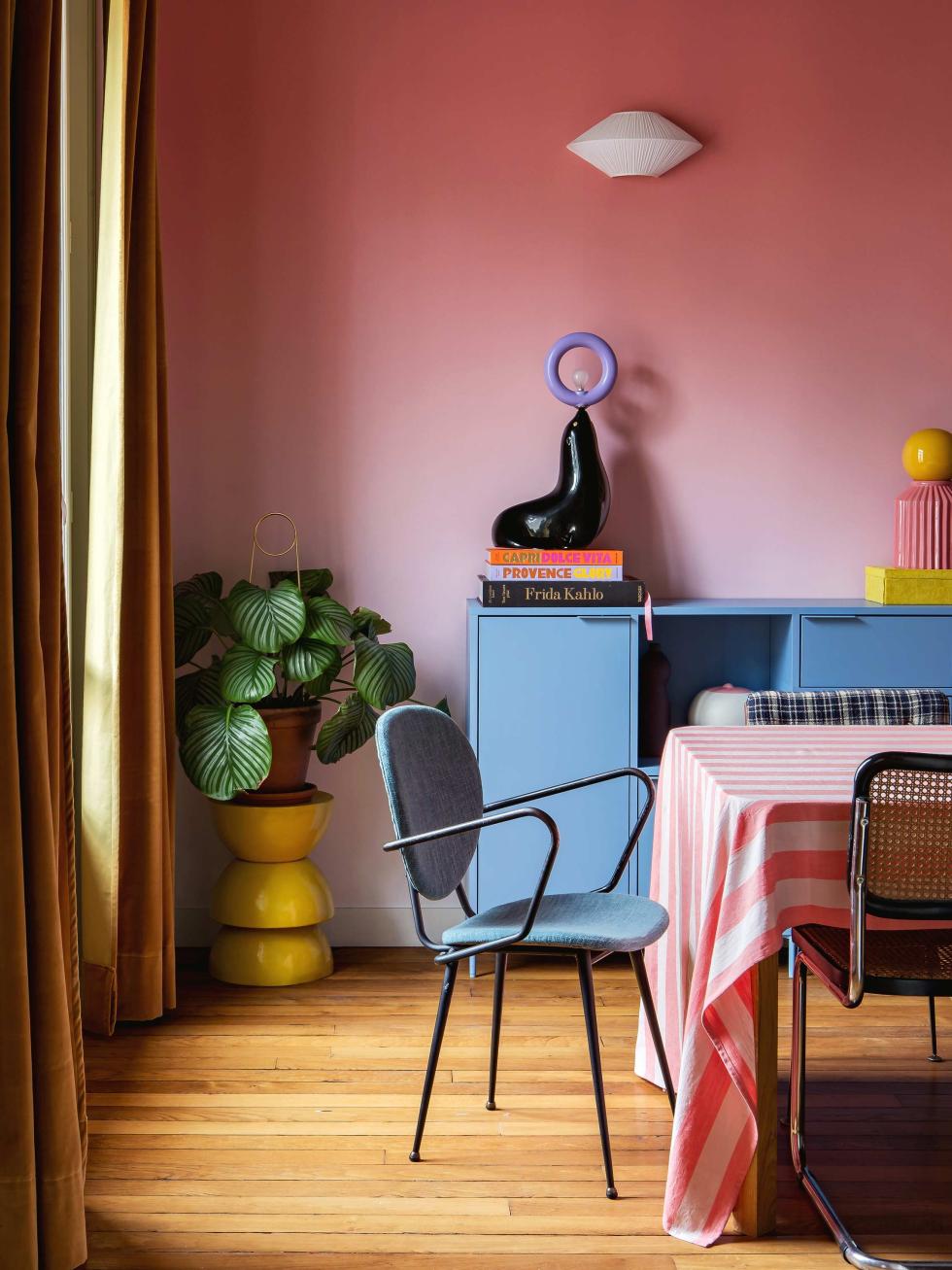 Lisa Gachet's colorful living room: green wall, purple carpet, corduroy sofa.
